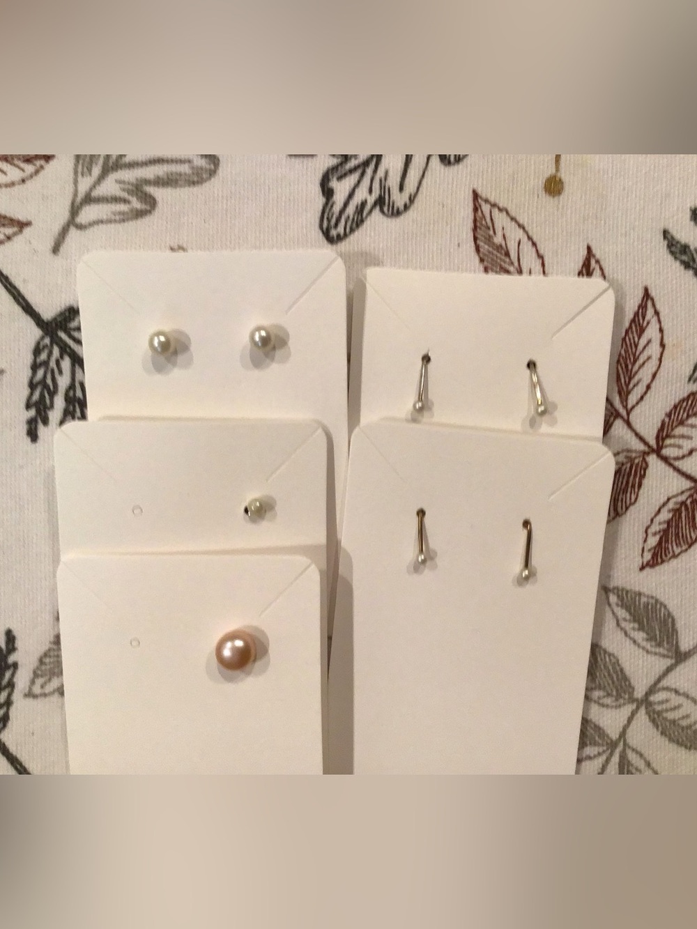 5 pearl pierced earrings. Two one pearl studs. One pair stud earrings. 2…